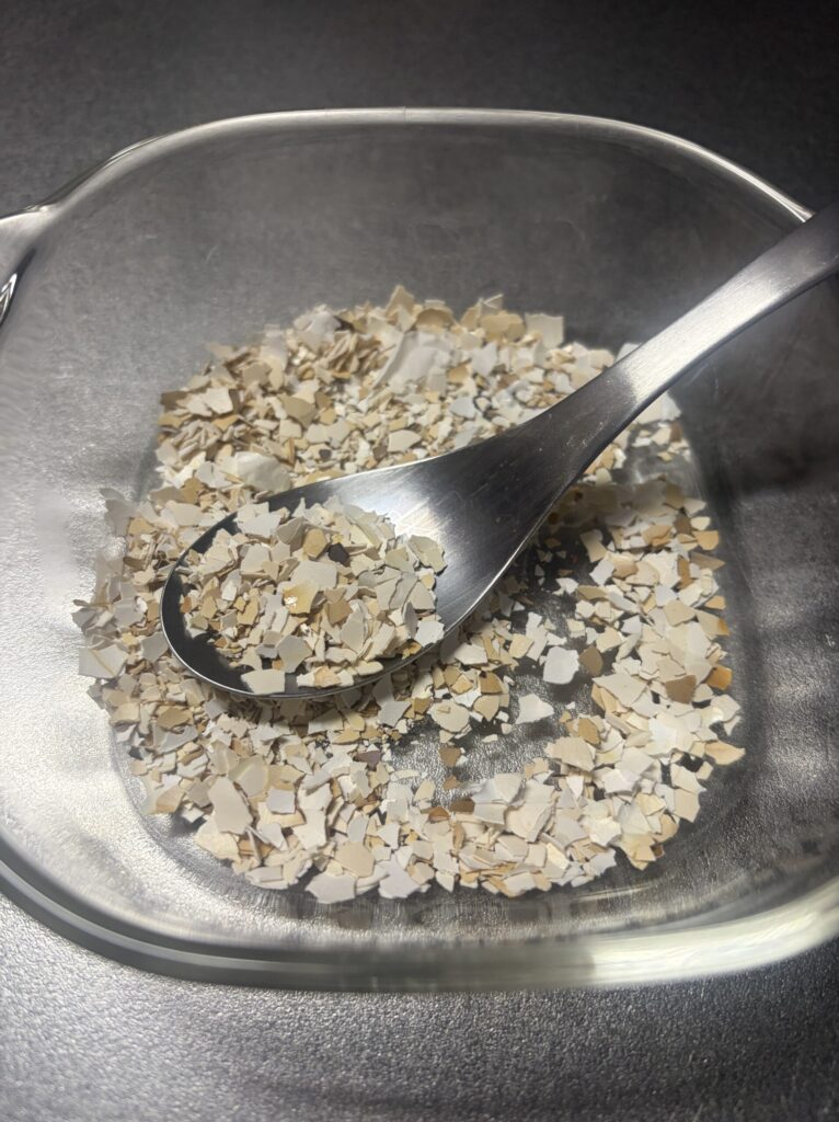 スプーンで卵の殻を細かく砕いた様子